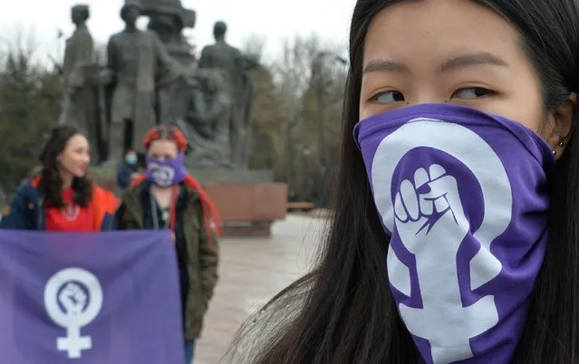 A woman wears a mask during a rally to mark the International Women's Day in Bishkek on March 8, 2021. Femen activists protested against patriarchy and for women's rights on the occasion of Women's Day celebrated across the world every year on March 8. (Photo by Vyacheslav Oseledko/AFP Photo)