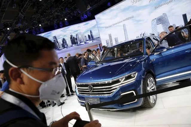 People gather around the Volkswagen's T-Prime Concept GTE hybrid SUV after it was presented during the Auto China 2016 auto show in Beijing April 25, 2016. (Photo by Damir Sagolj/Reuters)