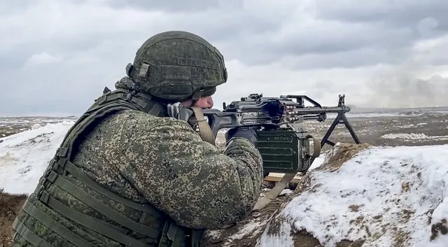 In this photo taken from video and released by the Russian Defense Ministry Press Service on Wednesday, February 2, 2022, a soldier fires during a Russian and Belarusian joint military drills at Brestsky firing range, Belarus. Russian and Belarus troops held joint combat training at firing ranges in Belarus Wednesday as tensions remain high under the looming threat of war with Ukraine. The drills involved motorized rifle, artillery and anti-tank missile units, as well tanks' and armoured personnel carriers' crews. (Photo by Russian Defense Ministry Press Service via AP Photo)