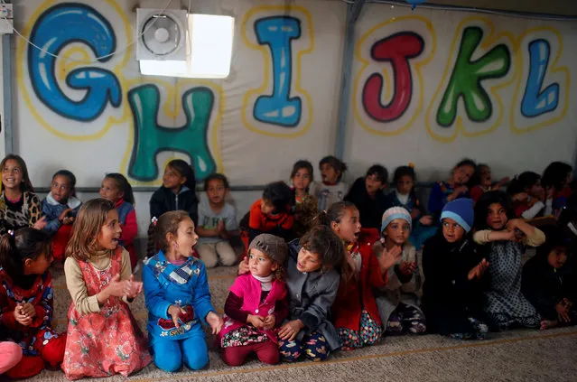 Displaced Iraqi children play inside a tent as they wait for the arrival of United Nations Secretary General Antonio Guterres during his visit at Hasansham camp, in Khazer, Iraq March 31, 2017. (Photo by Suhaib Salem/Reuters)