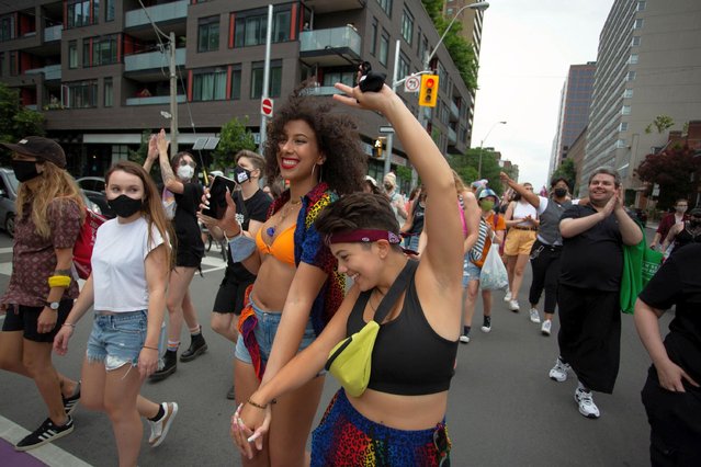 Participants join the annual Dyke March during Pride Month in Toronto, Ontario, Canada on June 26, 2021. (Photo by Nick Lachance/Reuters)