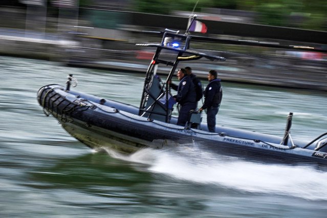 A police boat participates in a technical navigation rehearsal on the Seine river for the opening ceremony of the Paris 2024 Olympic Games, in Paris, on June 17, 2024. (Photo by Julien de Rosa/AFP Photo)