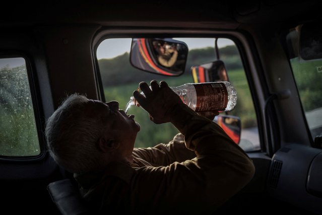 Indervir Singh, 54, a firefighter, drinks water as he sits inside a fire truck after an operation to control a fire that broke out at a car scrapyard in New Delhi, India on May 30, 2024. Singh has worked for the Delhi Fire Services for 32 years but he can't recall responding to as many fires as this summer. Calls reporting fires between April and June more than doubled from a year ago to over 9,000, fire services data show. And deaths from fires more than tripled in that period, from just 10 a year ago. “I have attended to several back-to-back calls” on recent shifts, said the grey-haired Singh before he rushed to the scene of yet another blaze in his thick jacket, heavy boots and red helmet. (Photo by Adnan Abidi/Reuters)