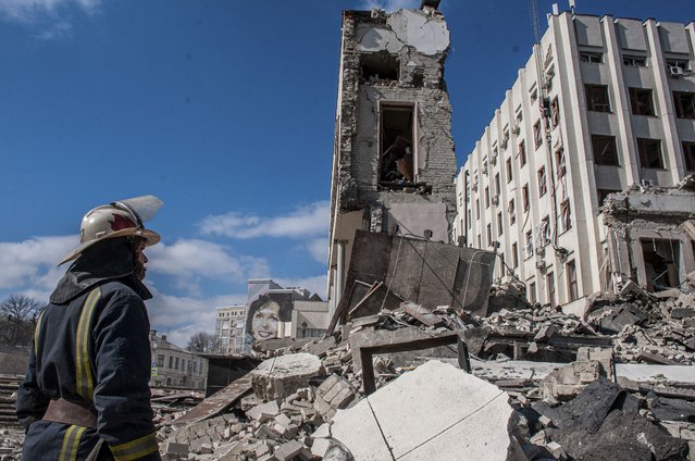 Rescuers work at the site of the National Academy of State Administration building damaged by shelling in Kharkiv, Ukraine, Friday, March 18, 2022. (Photo by Andrew Marienko/AP Photo)