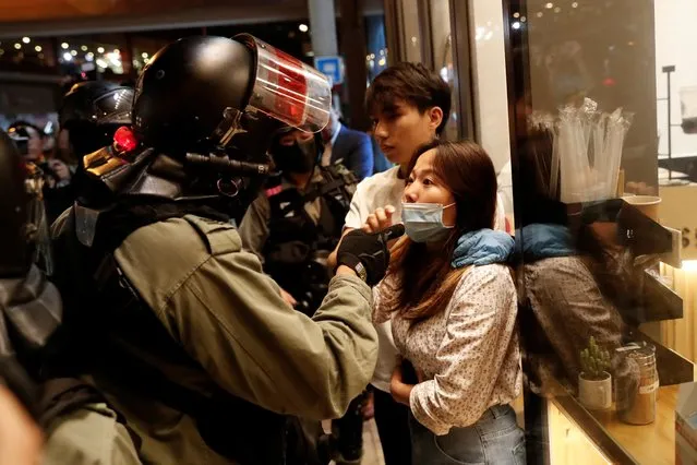 A member of riot police talks with a protester during an anti-government rally in Hong Kong, China on October 30, 2019. (Photo by Shannon Stapleton/Reuters)