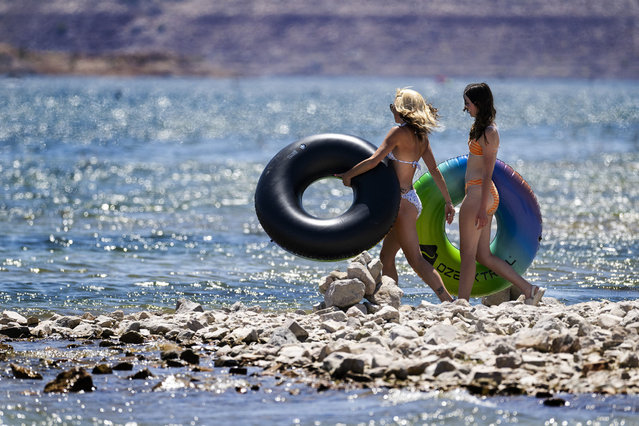 Two women walk into Lake Mead in Boulder City, Nevada, on June 8, 2024, as a heat wave continues to hit the area. (Photo by Jim Watson/AFP Photo)