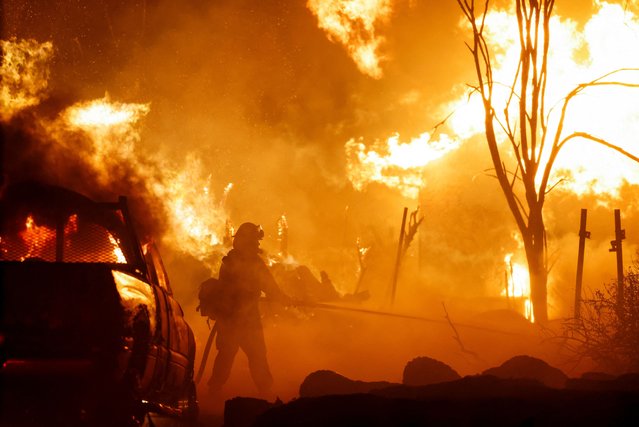 Firefighters work as Park Fire burns near Chico, California on July 25, 2024. (Photo by Fred Greaves/Reuters)