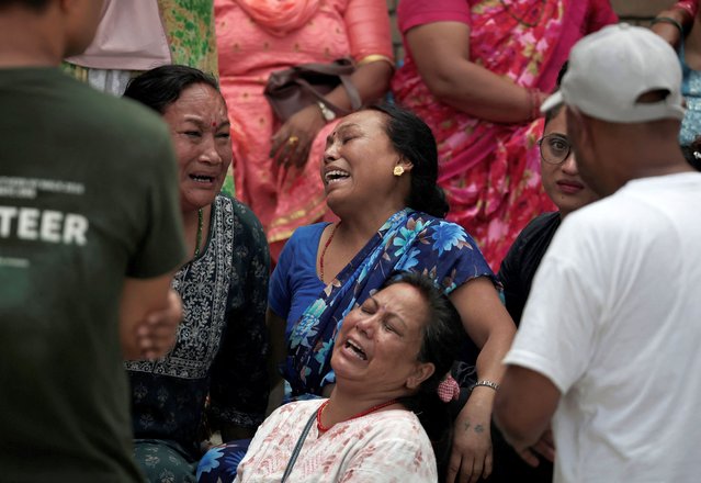 Family members of the victims react outside a hospital after a Saurya Airlines plane caught fire after skidding off the runway while taking off at Tribhuvan International Airport, in Kathmandu, Nepal, on July 24, 2024. (Photo by Navesh Chitrakar/Reuters)