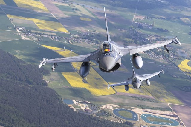 Romanian Air Force F- 16s military fighter jets participating in NATO's Baltic Air Policing Mission operate in Lithuanian airspace, Monday, May 22, 2023. (Photo by Mindaugas Kulbis/AP Photo)