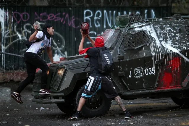Demonstrators clash with riot police during a protest against Chile's government in Santiago, Chile on December 12, 2019. (Photo by Ricardo Moraes/Reuters)