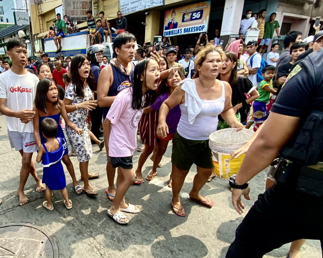 Filipino informal settlers argue with riot police during a demolition raid at a shanty town in Pasay City, Metro Manila, Philippines, 01 August 2024. According to a local government official, close to a hundred families were ejected from their shanties to give way for a developing firm turning the area into a business district. (Photo by Francis R. Malasig/EPA)