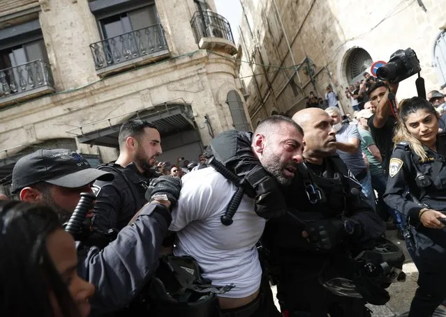 Israeli police arrest a man during a procession for slain American-Palestinian journalist Shireen Abu Akleh prior to her funeral, in the Old City of Jerusalem, 13 May 2022. Al Jazeera journalist Shireen Abu Akleh was killed on 11 May 2022 during a raid by Israeli forces in the West Bank town of Jenin. (Photo by Atef Safadi/EPA/EFE/Rex Features/Shutterstock)