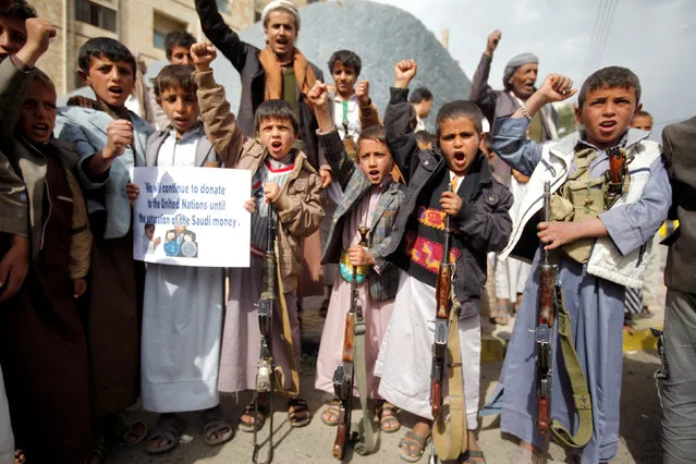 Boys shout slogans during a demonstration against the removal of the Saudi-led coalition from the United Nations annual child rights blacklist, outside the United Nations offices in Sanaa, Yemen, June 16, 2016. (Photo by Mohamed al-Sayaghi/Reuters)