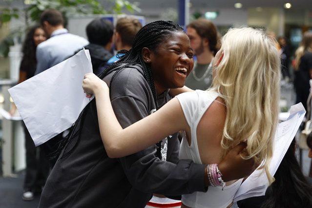 Khadija Senesie celebrates with a friend as she receives her GCSE results at the City of London Academy on August 24, 2023 in London, England. Average results for the General Certificate of Secondary Education (GSCE) exams, which were taken by Year 11 students across England and Wales this spring, are expected to be down from last year, after the end of pandemic-era modifications to the grading system. (Photo by Peter Nicholls/Getty Images)