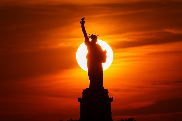 Sunset view with clouds behind the Statue of Liberty is seen from Brooklyn in New York City, United States on June 20, 2022. (Photo by Tayfun Coskun/Anadolu Agency via Getty Images)