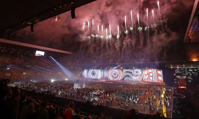 Fireworks explode overhead during the opening ceremony for the Commonwealth Games 2014 in Glasgow, Scotland, Wednesday July 23, 2014. (Photo by Kirsty Wigglesworth/AP Photo)