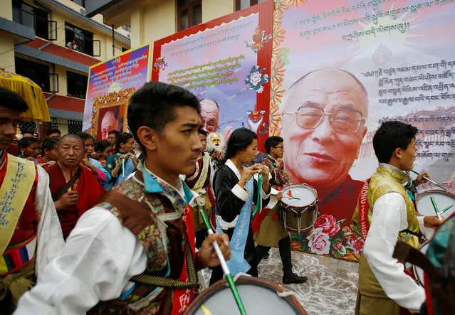 Tibetans wearing a traditional attire parade to celebrate the birthday of Dalai Lama in Kathmandu, Nepal, July 6, 2016. (Photo by Navesh Chitrakar/Reuters)