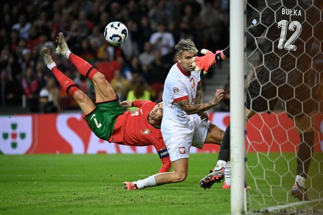 Portugal's forward Cristiano Ronaldo (L) scores their fifth goal during the UEFA Nations League, League A, Group 1 football match between Portugal and Poland at the Dragao stadium in Porto, on November 15, 2024. (Photo by Miguel Riopa/AFP Photo)
