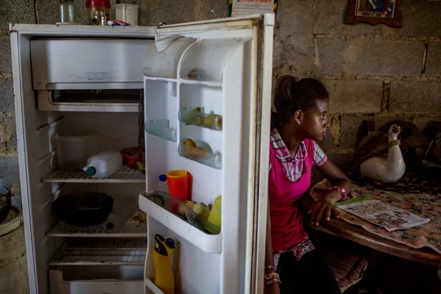 Andrea Sira, 11, at her home in Barlovento, the fridge held the food in the house, water and mangos. (Photo by Alejandro Cegarra/The Washington Post)