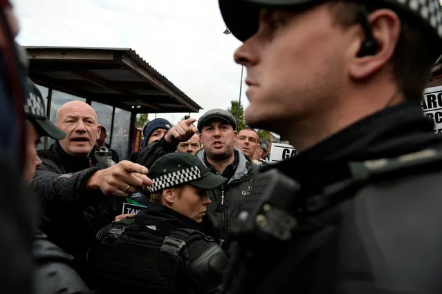Members of the Greater Ardoyne Residents Coalition GARC are seen in a stand off with Police as they wait for the Twelfth of July  Orange Order March to come down the Crumlin Road in Belfast, Northern Ireland, July 12, 2016. (Photo by Clodagh Kilcoyne/Reuters)