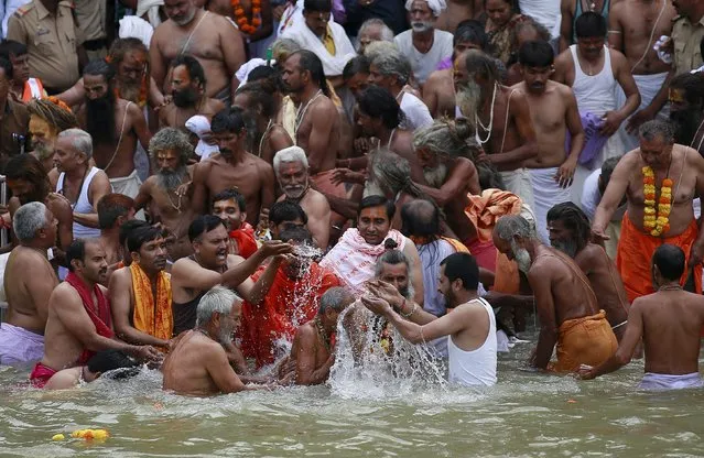 Sadhus or Hindu holy men take a dip  in the Godavari river during the first Shahi Snan (grand bath) at Kumbh Mela, or Pitcher Festival in Nashik, India, August 29, 2015. (Photo by Danish Siddiqui/Reuters)