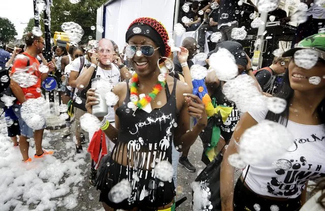 Dancers are covered in bubbles at the Notting Hill Carnival in London, Britain, August 30, 2015. (Photo by Kevin Coombs/Reuters)