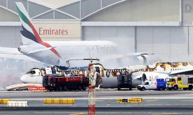An Emirates airlines Boeing 777-300 A6-EMW plane flight number EK521 from Trivandrum to Dubai lays on the ground in Dubai airport after being gutted by fire due to a mechanical failure at Dubai international airport, Dubai, United Arab Emirates, 03 August 2016. According to Emirates airlines, no fatalities in the 282 passengers and the 18 crew members. (Photo by EPA/Stringer)
