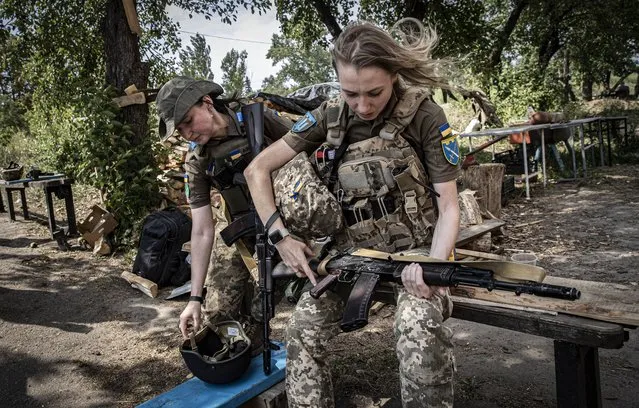 Svetlana, a Captain in the Ukrainian Armed Forces (L) and Irina, volunteered to join the army (R) are seen on the frontline in Donbass, Donetsk, Ukraine on August 15, 2022. (Photo by Metin Aktas/Anadolu Agency via Getty Images)