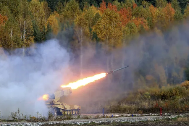A Russian “TOS-1 Buratino” multiple rocket launcher fires during the “Russia Arms Expo 2013”, the 9th international exhibition of arms, military equipment and ammunition in the Urals city of Nizhny Tagil on September 26, 2013. (Photo by Sergei Karpukhin/Reuters)