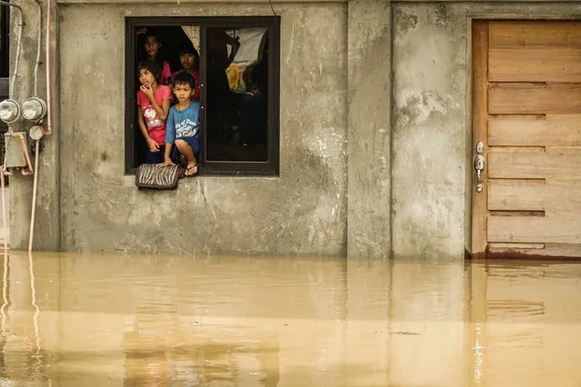 Villagers stays inside the flooded house brought by super typhoon Noru at San Ildefonso in Bulacan on September 26, 2022. (Photo by Dante Diosina Jr/Anadolu Agency via Getty Images)