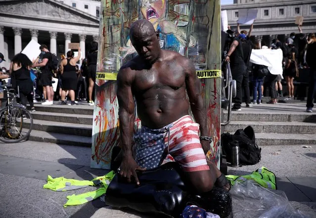 A protester performs during “I can't breathe” vigil and rally against the death in Minneapolis police custody of African-American man George Floyd, in New York, U.S. May 29, 2020. (Photo by Caitlin Ochs/Reuters)