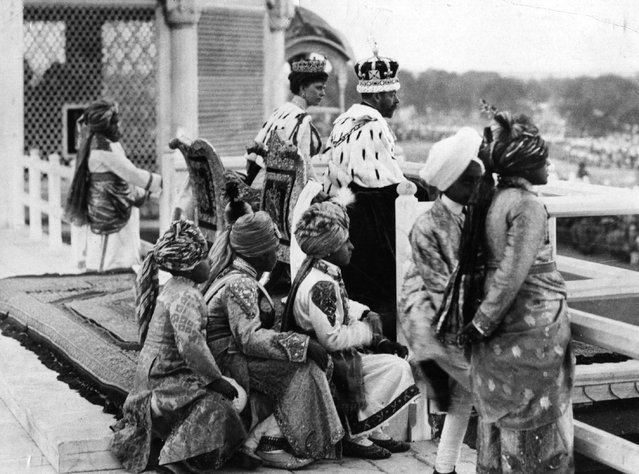 King George V (1865–1936) and Queen Mary (1867–1953) attended by young Indian princes, on the balcony of the Red Fort, Delhi, for the Great Durbar held in honour of the King's accession to the throne, 1911. (Photo by Hulton Archive)
