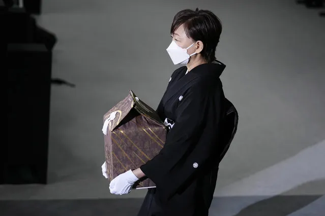 Akie Abe, wife of former Prime Minister Shinzo Abe, carries a cinerary urn containing his ashes at his state funeral, Tuesday, September 27, 2022, in Tokyo. Abe was assassinated in July. (Photo by Franck Robichon/Pool photo via AP Photo)