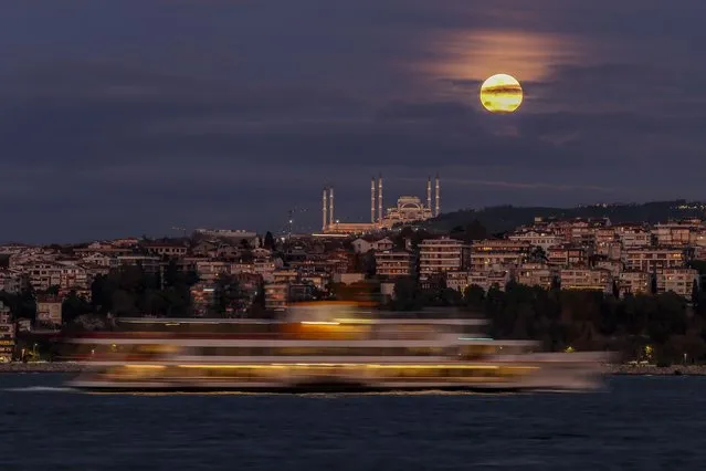 A full moon rises behind the Camlica mosque in Istanbul, Turkey, Tuesday, November 8, 2022. (Photo by Emrah Gurel/AP Photo)