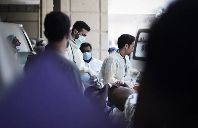 Saudi medics tend to injured pilgrims after they arrived by ambulance at an emergency hospital following a deadly stampede in Mina, near the holy city of Mecca, on the first day of Eid al-Adha on September 24, 2015. (Photo by Mohammed Al-Shaikh/AFP Photo)