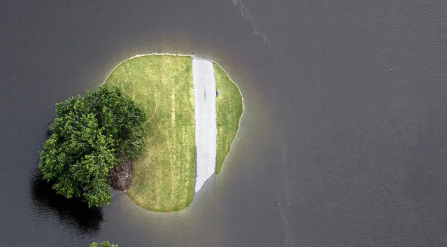 This aerial photo shows flooding around Aberdeen Country Club, Tuesday, October 6, 2015, in Longs. S.C.. The Carolinas saw sunshine Tuesday after days of inundation, but it could take weeks to recover from being pummeled by a historic rainstorm that caused widespread flooding and multiple deaths. (Photo by Janet Blackmon Morgan/The Sun News via AP Photo)
