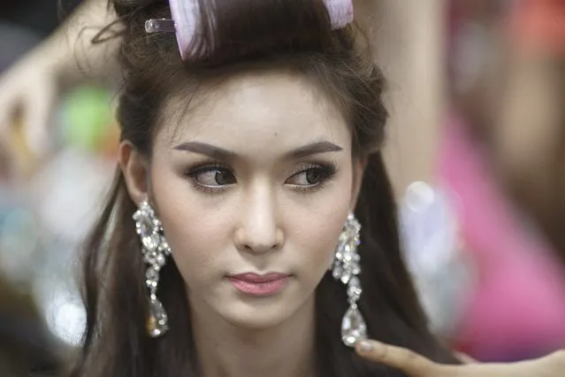 Contestant Piyada Inthavong of Laos prepares backstage before the final show of the Miss International Queen 2014 transgender/transsexual beauty pageant in Pattaya November 7, 2014. Some 22 contestants from 18 countries, all born male, competed in the week-long event for the crown of Miss International Queen. (Photo by Athit Perawongmetha/Reuters)