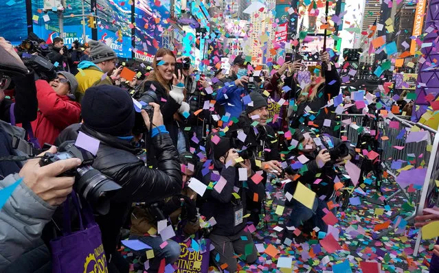 Photographers record a confetti test run in preparation for the New Year's Eve celebration in Times Square, New York City, on December 29, 2022. Times Square Alliance and Countdown Entertainment, co-organizers of Times Square New Year's Eve, conduct the annual confetti test ahead of the release of 1.5 tons (1,361kgs) of confetti at midnight on December 31. (Photo by Timothy A. Clary/AFP Photo)