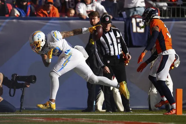 Los Angeles Chargers wide receiver Keenan Allen (13) scores a touchdown past Denver Broncos safety Justin Simmons (31) during the first half of an NFL football game in Denver, Sunday, January 8, 2023. (Photo by Jack Dempsey/AP Photo)