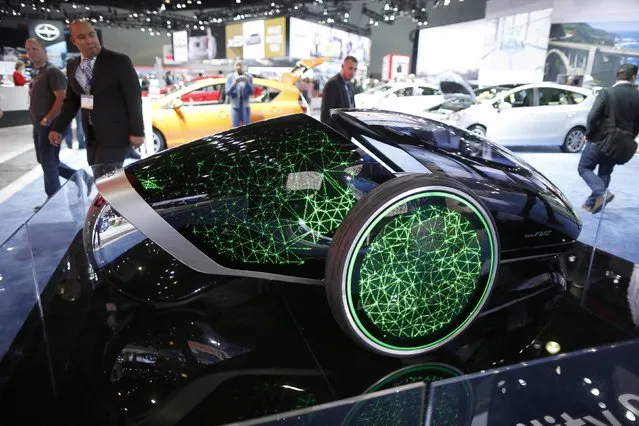People view a Toyota Future Mobility Concept car at the 2014 Los Angeles Auto Show in Los Angeles, California November 20, 2014. (Photo by Lucy Nicholson/Reuters)