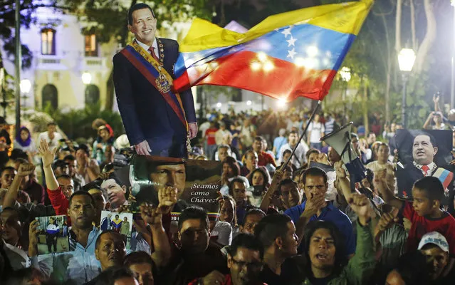 Supporters of Venezuela's President Hugo Chavez react to the announcement of his death in Caracas, March 5, 2013. Chavez has died after a two-year battle with cancer, ending the socialist leader's 14-year rule of the South American country, Vice President Nicolas Maduro said in a televised speech on Tuesday. (Photo by Jorge Silva/Reuters)