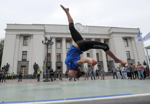 Students of Kiev's Olympic College perform during a rally in front of the Parliament building in Kiev, Ukraine, 15 September 2020. Students were protesting against the reorganization of the college, at risk of being closed, and the land where it rises which could end up for sale along with the facility's stadium. (Photo by Sergey Dolzhenko/EPA/EFE)
