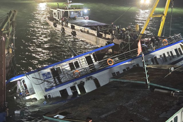 A handout photo made available by the Vietnam News Agency shows a tourist boat being salvaged in Ha Long Bay, Quang Ninh province, Vietnam, 20 July 2025. At least 38 people died and fives people are still missing after a tourist boat carrying 53 people onboard capsized in Ha Long Bay on 19 July, according to state media. (Photo by Vietnam News Agency/EPA)