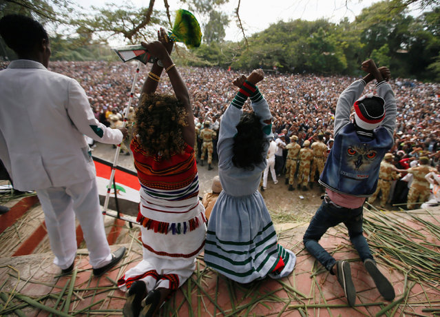 Demonstrators chant slogans while flashing the Oromo protest gesture during Irreecha, the thanksgiving festival of the Oromo people, in Bishoftu town, Oromia region, Ethiopia, October 2, 2016. (Photo by Tiksa Negeri/Reuters)