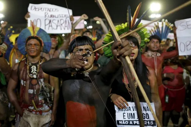 Indigenous people from several tribes take part in a protest against the approval of the Proposed Constitutional Amendment (PEC 215) during the first World Games for Indigenous Peoples in Palmas, Brazil, October 28, 2015. (Photo by Ueslei Marcelino/Reuters)