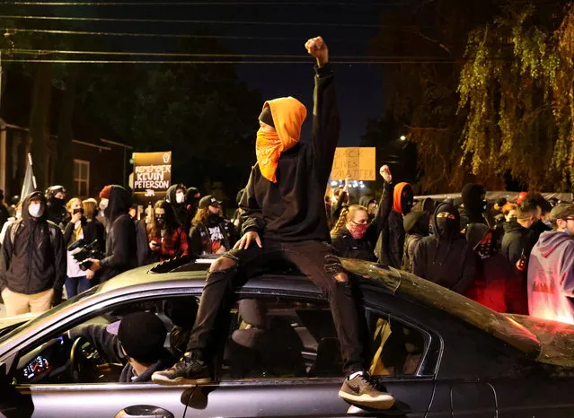 A demonstrator holds up a fist during a protest  in Vancouver, Washington, U.S. October 31, 2020. (Photo by Goran Tomasevic/Reuters)
