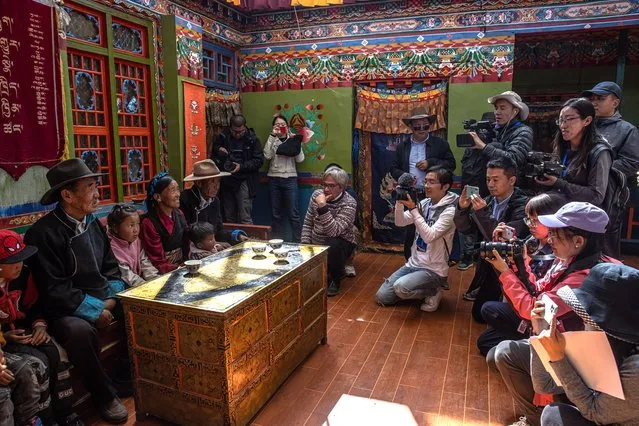 Journalists visit a Tibetan family in Jangdam village, Samzhubze District, outside Shigatse, in Tibet Autonomous Region, China, 18 October 2020. The picture was taken during a media tour to Tibet organized by the Chinese government that focused on China's poverty alleviation program for the region. The natural beauty of Tibet, the thousand-year-old Himalayan roof of the world, still dazzles the few visitors who are allowed in. But today, in many places, bulldozers, highways, and modern apartment towers have replaced the grazing yaks and the chanting Buddhist monks. According to the Beijing government, extreme poverty – an endemic problem in Tibet, where pastoralism has traditionally been the sole source of income for most people – has been eradicated. In recent years, the central government has made colossal investments in Tibet, both in infrastructure and poverty reduction programs. Since 2016, Beijing has invested 74.85 billion yuan (USD 11.1 billion) in projects to improve access to health, education, clean water, housing, or infrastructure in the region's poorest areas. (Photo by Roman Pilipey/EPA/EFE)