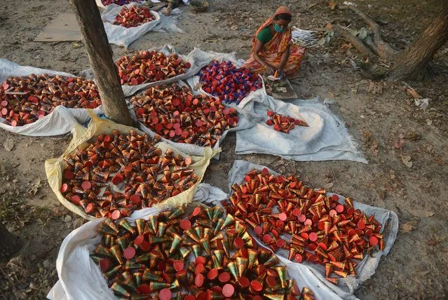Indian labourers work at Raj firecracker factory in Liusipukuri village, on the outskirts of Siliguri on November 4, 2015. Firecrackers are used during celebrations for Diwali, the Festival of Lights which falls on November 11 this year, marking the victory of good over evil and commemorating Hindu god Lord Rama's victory over Ravana. (Photo by Diptendu Dutta/AFP Photo)