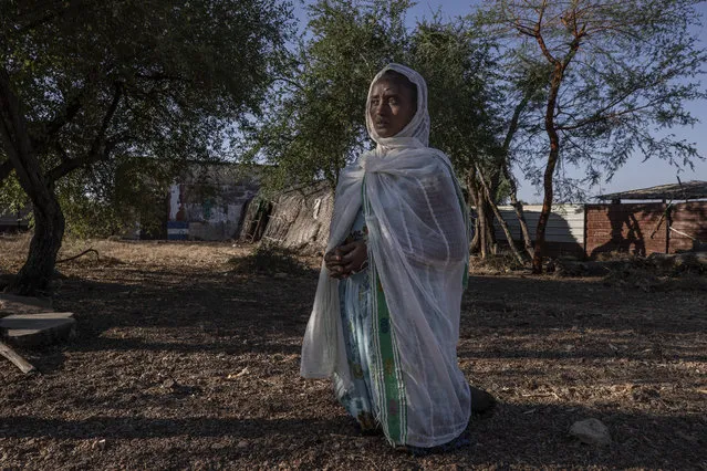 A Tigrayan woman who fled the conflict in Ethiopia's Tigray region, prays after Sunday Mass ends at a church, near Umm Rakouba refugee camp in Qadarif, eastern Sudan, November 29, 2020. (Photo by Nariman El-Mofty/AP Photo)