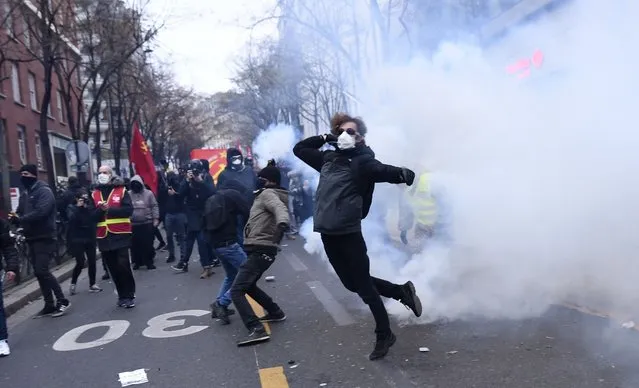 People attend a protest against the PPL Global Security Law in Paris, France on December 05, 2020. Demonstrators clash with security officers during their intervention. (Photo by Julien Mattia/Anadolu Agency via Getty Images)